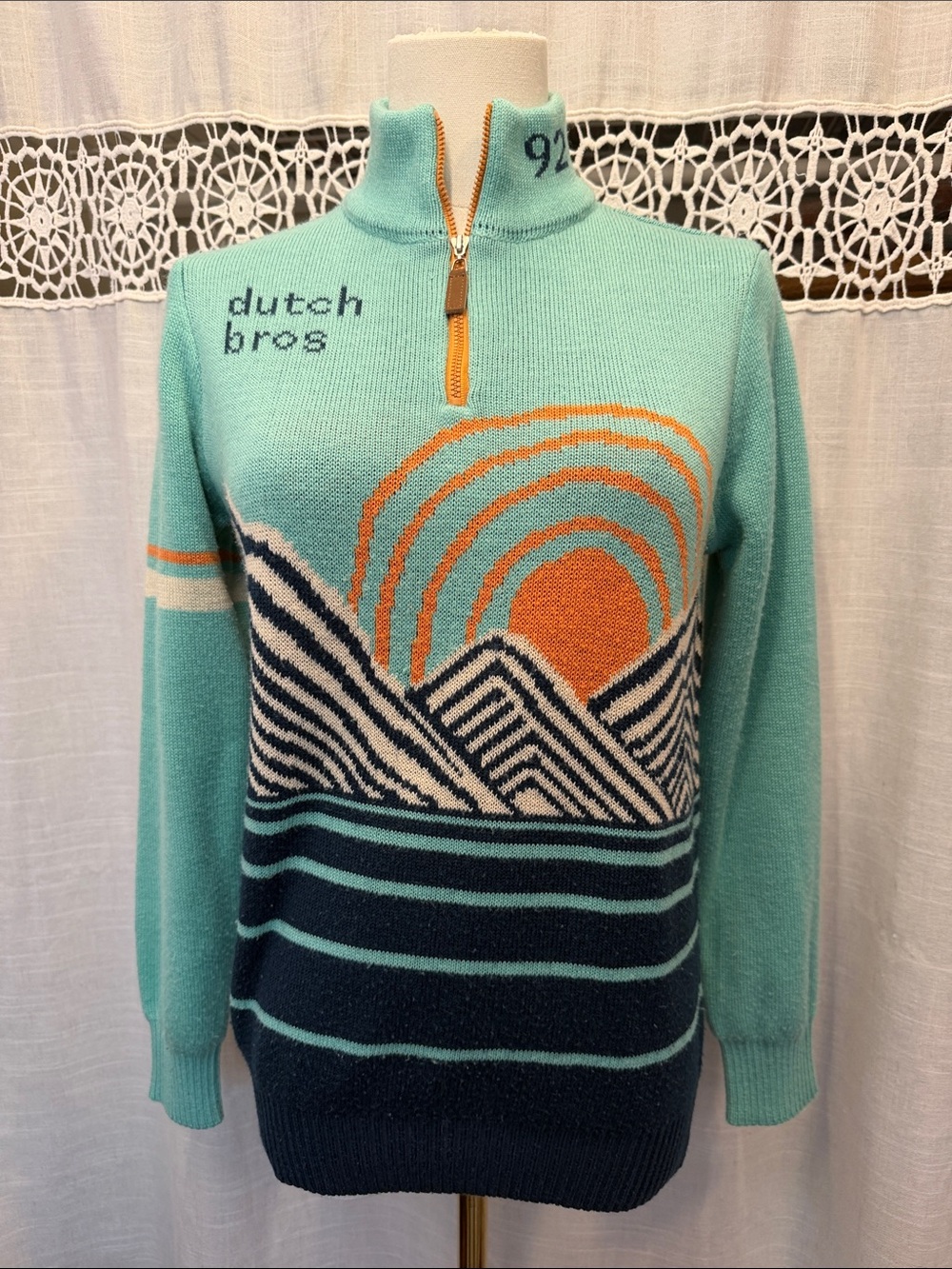 Dutch Bros Aqua Zip-Neck Sweater with Orange Sunset and Navy Waves